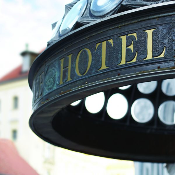 Close up of hotel header incription. Golden letters. Shallow DOF.